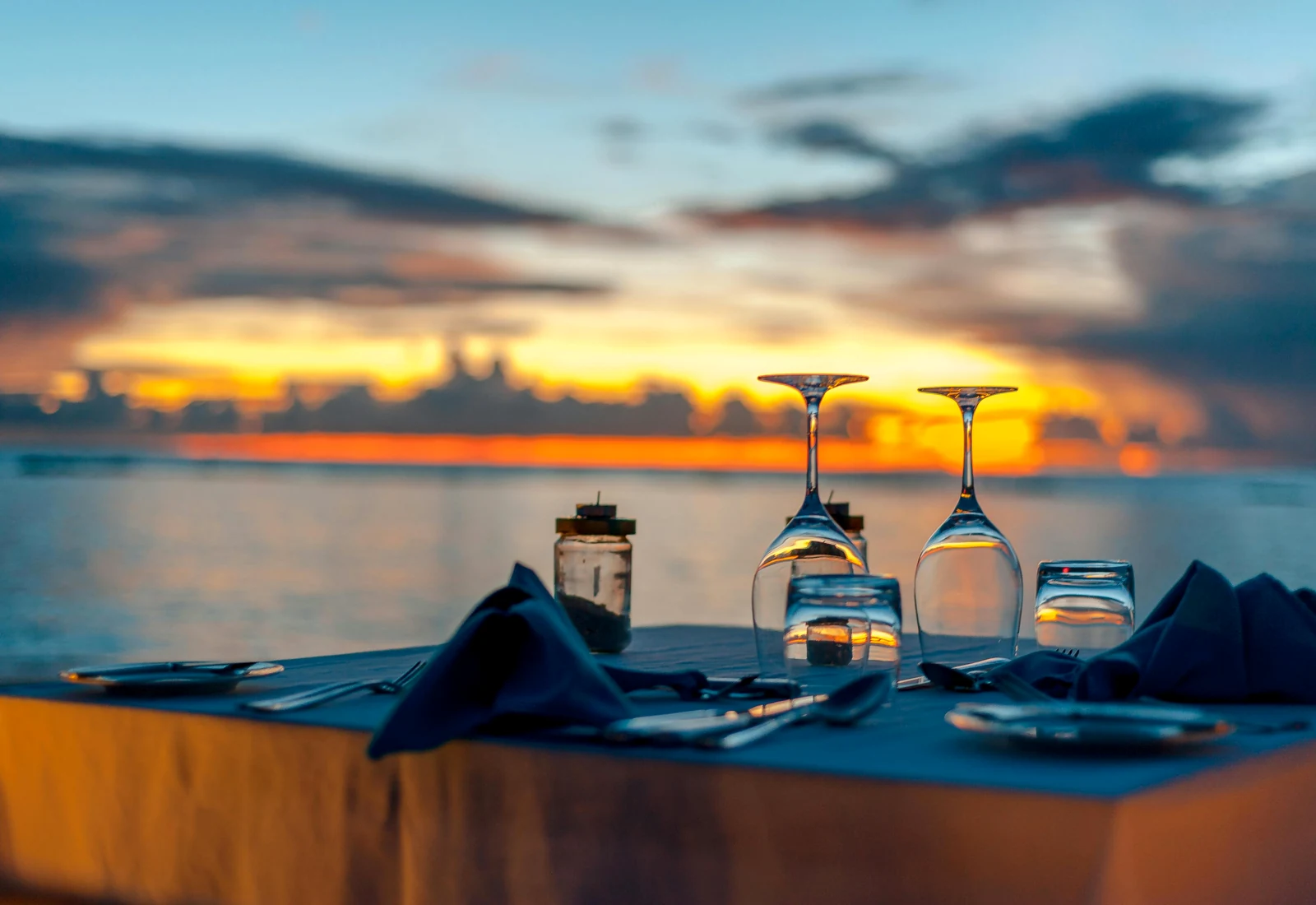 Elegant beachfront dinner at sunset